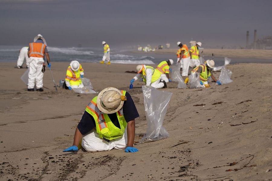 Cleanup crew working on oil-covered beach